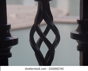 Stylish patterned wrought iron railing on a balcony overlooking the water