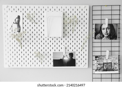 Stylish Peg Board With Photos And Book Hanging On Light Grey Wall