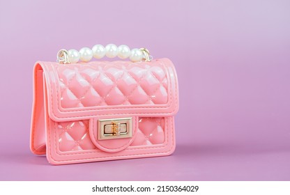 Stylish pink ladies handbag isolated on background.