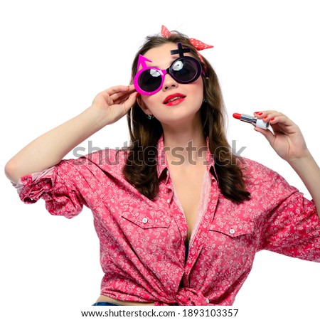 Stylish pinup woman paints her lips with red lipstick. Isolated on white background, vintage retro style