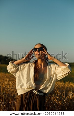 Similar – Image, Stock Photo Happy blonde woman with sunglasses and a hat enjoying the sun in nature