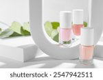 Stylish presentation of nail polishes in bottles on white table