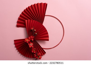 Stylish Red paper fan, circle, and red blossom, and on pink background. Chinese new year decoration. Traditional Japanese style. Wall decoration ideas. - Powered by Shutterstock