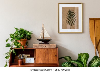 Stylish Retro Composition Of Home Office Interior With Vintage Wooden Cabinet, Ship, Plants, Clock, Paddle And Elegant Accessories. Gold Mock Up Poster Frame. Retro Home Decor. Marine Concept Template