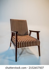 Stylish Retro Striped Armchair With Armrests On A White Cyclorama