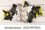 Stylish roller skates on blue background, top view. Inline skates on wooden background, extreme sports background