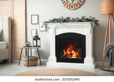 Stylish Room Decorated With Beautiful Eucalyptus Garland On Fireplace