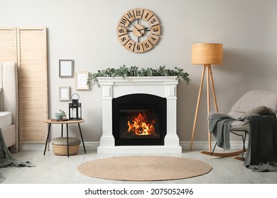 Stylish Room Decorated With Beautiful Eucalyptus Garland On Fireplace