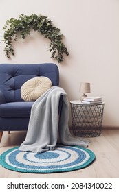 Stylish Room Decorated With Beautiful Eucalyptus Garland Above Comfortable Armchair