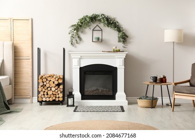 Stylish Room Decorated With Beautiful Eucalyptus Garland Above Fireplace