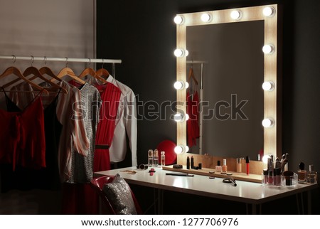 Stylish room with dressing table, mirror and wardrobe rack