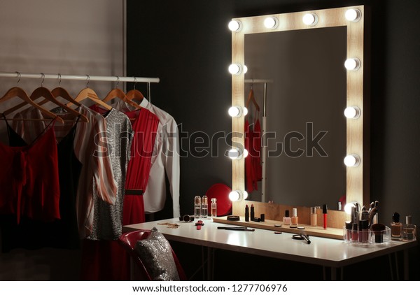 Stylish room with dressing table, mirror and\
wardrobe rack