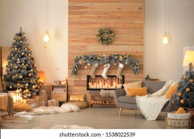 Stylish Room Interior With Beautiful Christmas Tree And Decorative Fireplace