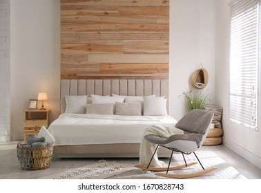 Stylish room interior with big comfortable bed - Shutterstock ID 1670828743
