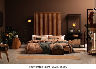 Stylish Room Interior With Large Bed Near Brown Wall