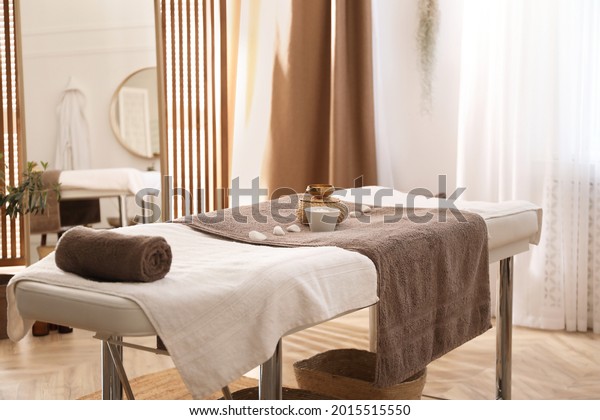 Stylish\
room interior with massage table in spa\
salon