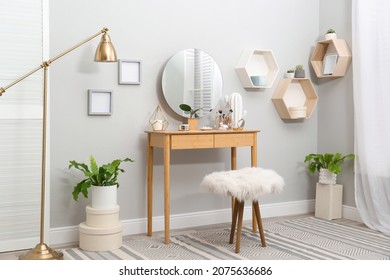 Stylish Room Interior With Wooden Dressing Table And Mirror On Light Wall