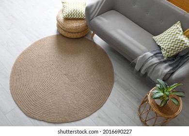 Stylish rug on floor in living room, above view
