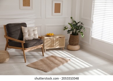 Stylish Rug On Floor Near Armchair In Room