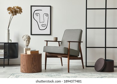 Stylish scandinavian composition of living room with design armchair, black mock up poster frame, commode, wooden stool, book, decoration, loft wall and personal accessories in modern home decor.