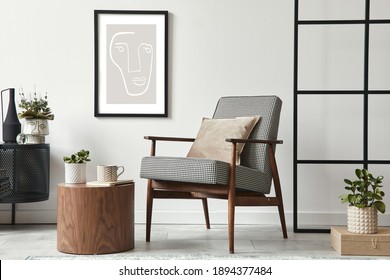 Stylish Scandinavian Composition Of Living Room With Design Armchair, Black Mock Up Poster Frame, Commode, Wooden Stool, Book, Decoration, Loft Wall And Personal Accessories In Modern Home Decor.