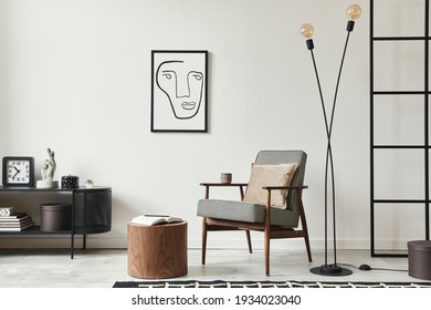 Stylish scandinavian composition of living room with design armchair, black mock up poster frame, commode, wooden stool, lamp, decoration, loft wall and personal accessories in modern home decor.