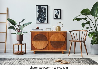 Stylish scandinavian composition of living room with design commode, black mock up poster frames, chair, wooden stool, book, decoration, plants and personal accessories in modern home decor.