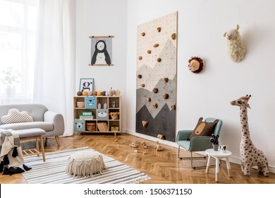 Stylish scandinavian interior design of childroom with gray sofa, modern climbing wall for kids, design furnitures, soft toys, teddy bear and cute children's accessories. Home decor. Template.  - Powered by Shutterstock