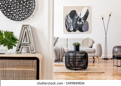 Stylish scandinavian living room interior with modern sofa, wooden commode, stylish lamps, plants, rattan basket and elegant personal accessories. Mock up paintings on the white wall. Template.  - Shutterstock ID 1499849834