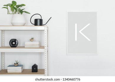 Stylish scandinavian open space interior with white bookstand, plant ,accessorries and mock up poster frame. Concept of mockup poster with white stand. White baclgrounds wall.