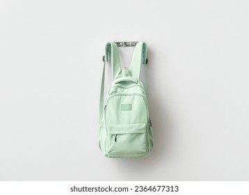 Stylish school backpack hanging on light wall - Powered by Shutterstock