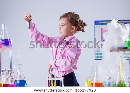 Similar – Image, Stock Photo Serious little boy playing with chemical liquids