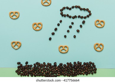 Stylish set: Coffee beans in shape of rainy cloud and pretzel on pastel blue and green backgrounds. Flat lay. Top view. - Powered by Shutterstock