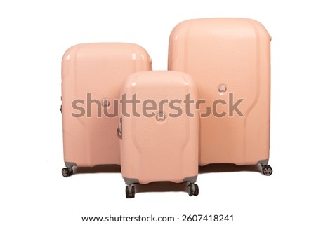 A stylish set of three hard-shell suitcases in a warm peach color, perfect for travel. Durable, modern, and elegant luggage for all your trips.