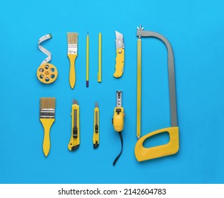 A Stylish Set Of Yellow Hand Tools On A Blue Background. The Concept Of Repair And Construction. Flat Lay.