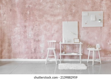 Stylish Shelf With Peg Board On Pink Textured Wall Background