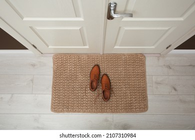 Stylish shoes on door mat in hall, top view - Powered by Shutterstock