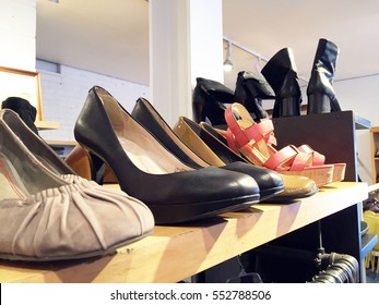 Stylish Shoes On Top Of A Clothing Rack In A Store In A Mall