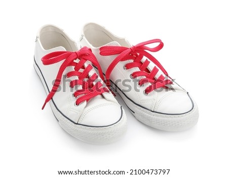 Stylish shoes with red laces on white background