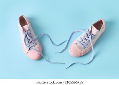 Stylish Shoes With Untied Laces On Blue Background