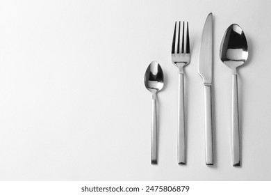 Stylish silver cutlery on white background, flat lay. Space for text - Powered by Shutterstock