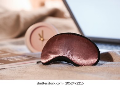 Stylish Sleeping Mask And Magazine On Bed In Room