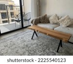 Stylish sofa and coffee table in an open plan living room with a view of the balcony