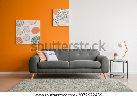 Stylish sofa with table in living room