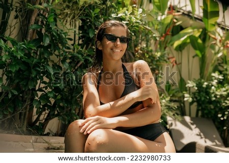 Similar – Brunette surfer woman with top and bikini holding surfboard