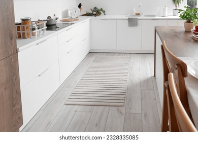 Stylish striped rug in interior of modern kitchen - Shutterstock ID 2328335085