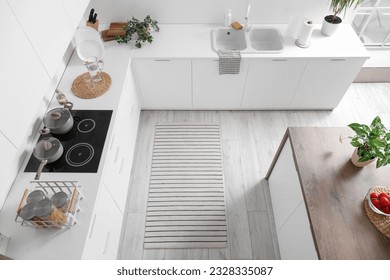 Stylish striped rug in interior of modern kitchen - Shutterstock ID 2328335087