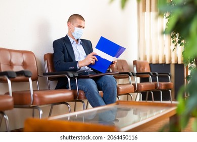 Stylish Successful Man In Face Mask With Briefcase Waiting For Job Interview In Office Lobby