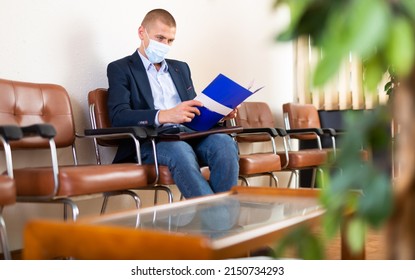 Stylish Successful Man In Face Mask With Briefcase Waiting For Job Interview In Office Lobby