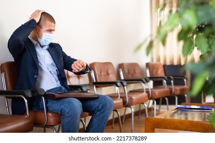 Stylish Successful Man In Face Mask With Briefcase Waiting For Job Interview In Office Lobby